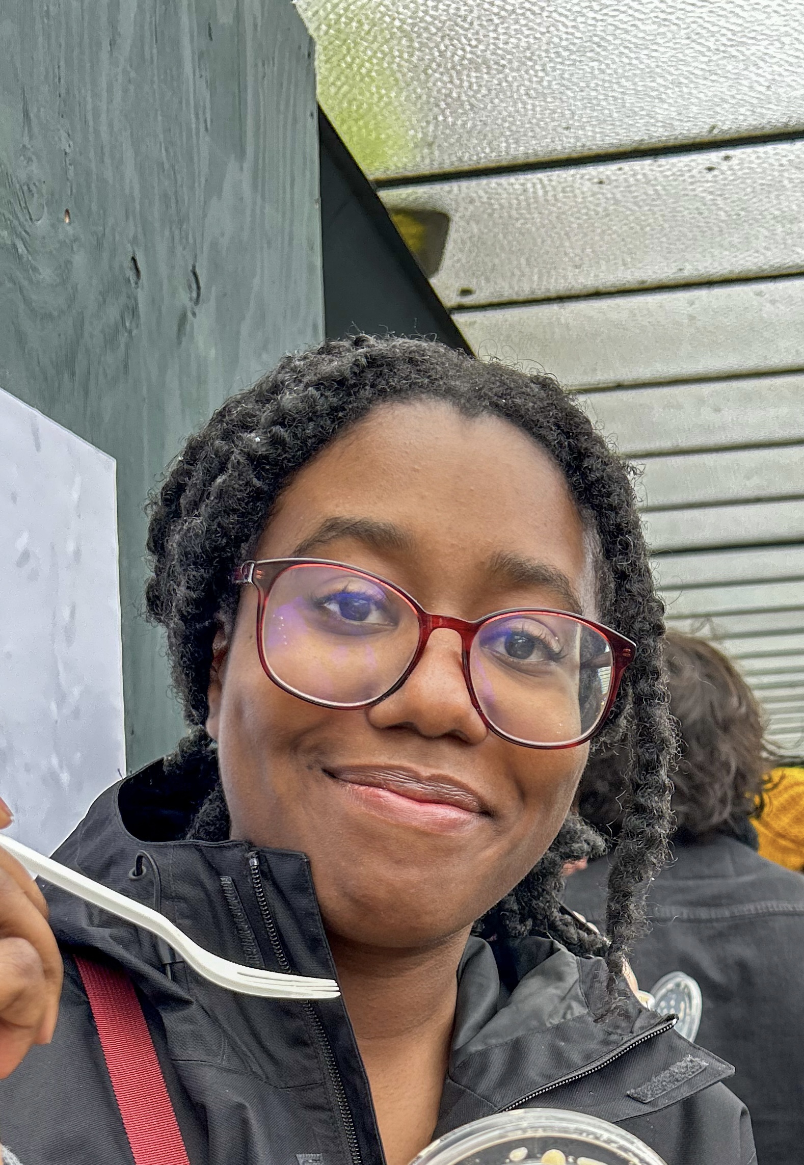 Image of Lauryn smiling holding a fork
